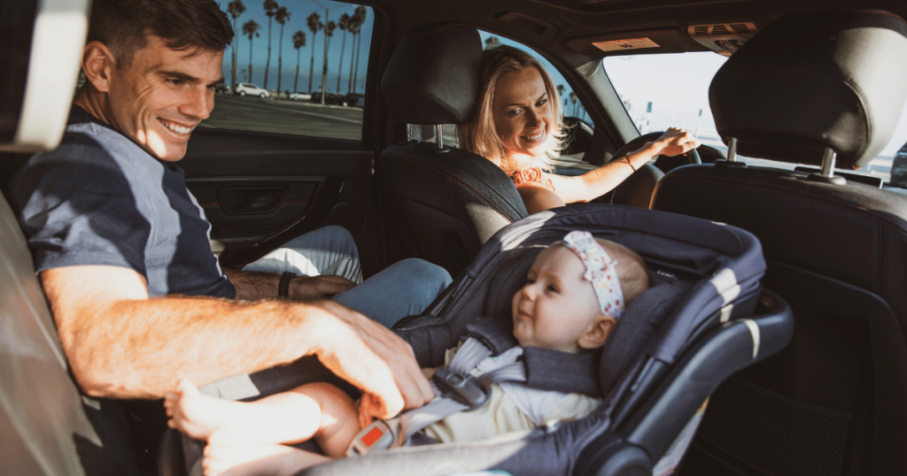 Rear facing baby capsule in the car with mum and dad.
