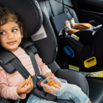 Toddler and baby in Britax car seats, following car seat safety guidelines.