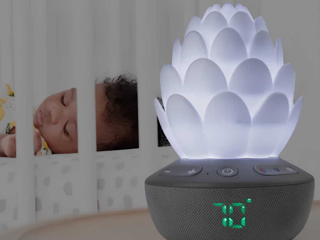 White lotus baby night light and sound machine on nursery shelf