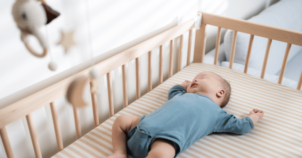 Baby sleeping in a cot.