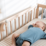 Baby sleeping in a cot.